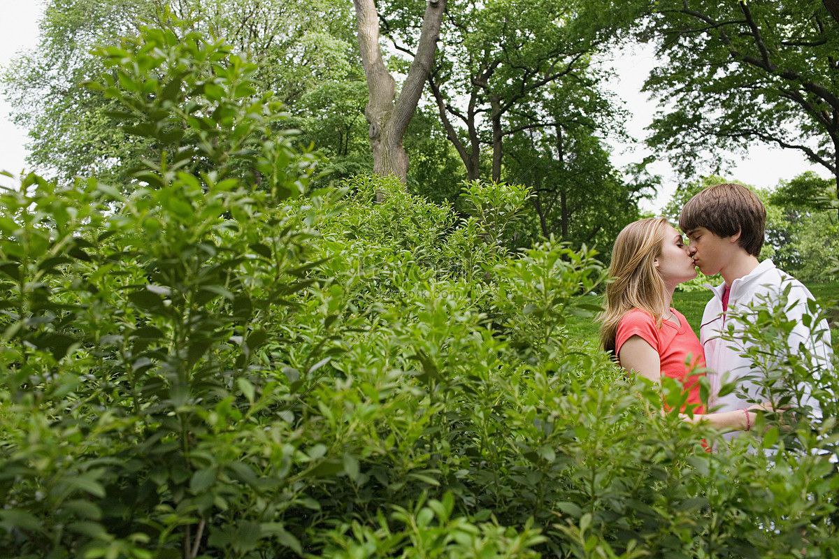Человек прячется в кустах. Куст. Человек в засаде в кустах. Влюбленные лежат на траве. Поцелуй в кустах.